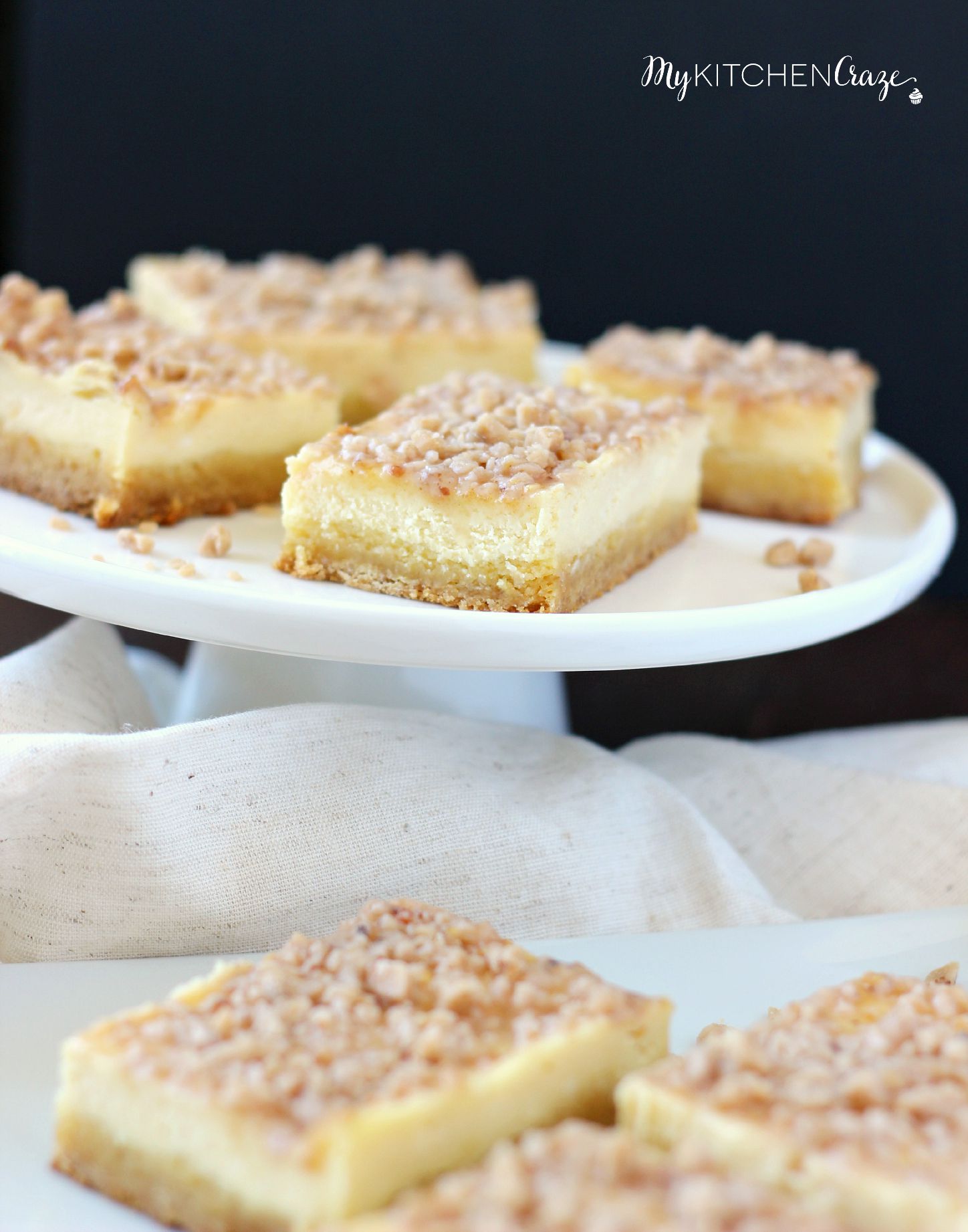 Toffee Cheesecake Bars ~ mykitchencraze ~ These bars are not only easy to throw together, but taste amazing! Sugar cookie bottom. Topped with a creamy cheesecake and sprinkled with toffee bits. What more could you ask for?