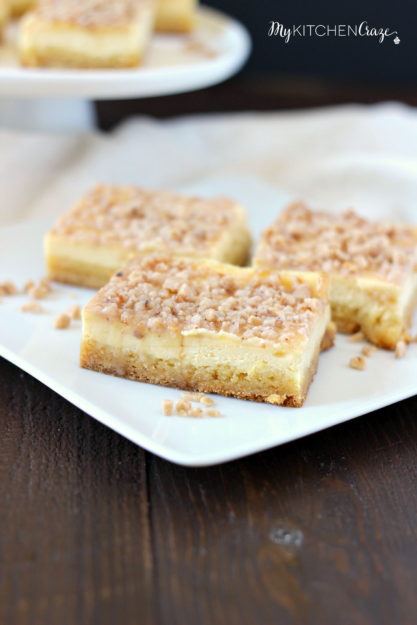 Toffee Cheesecake Bars ~ mykitchencraze ~ These bars are not only easy to throw together, but taste amazing! Sugar cookie bottom. Topped with a creamy cheesecake and sprinkled with toffee bits. What more could you ask for?