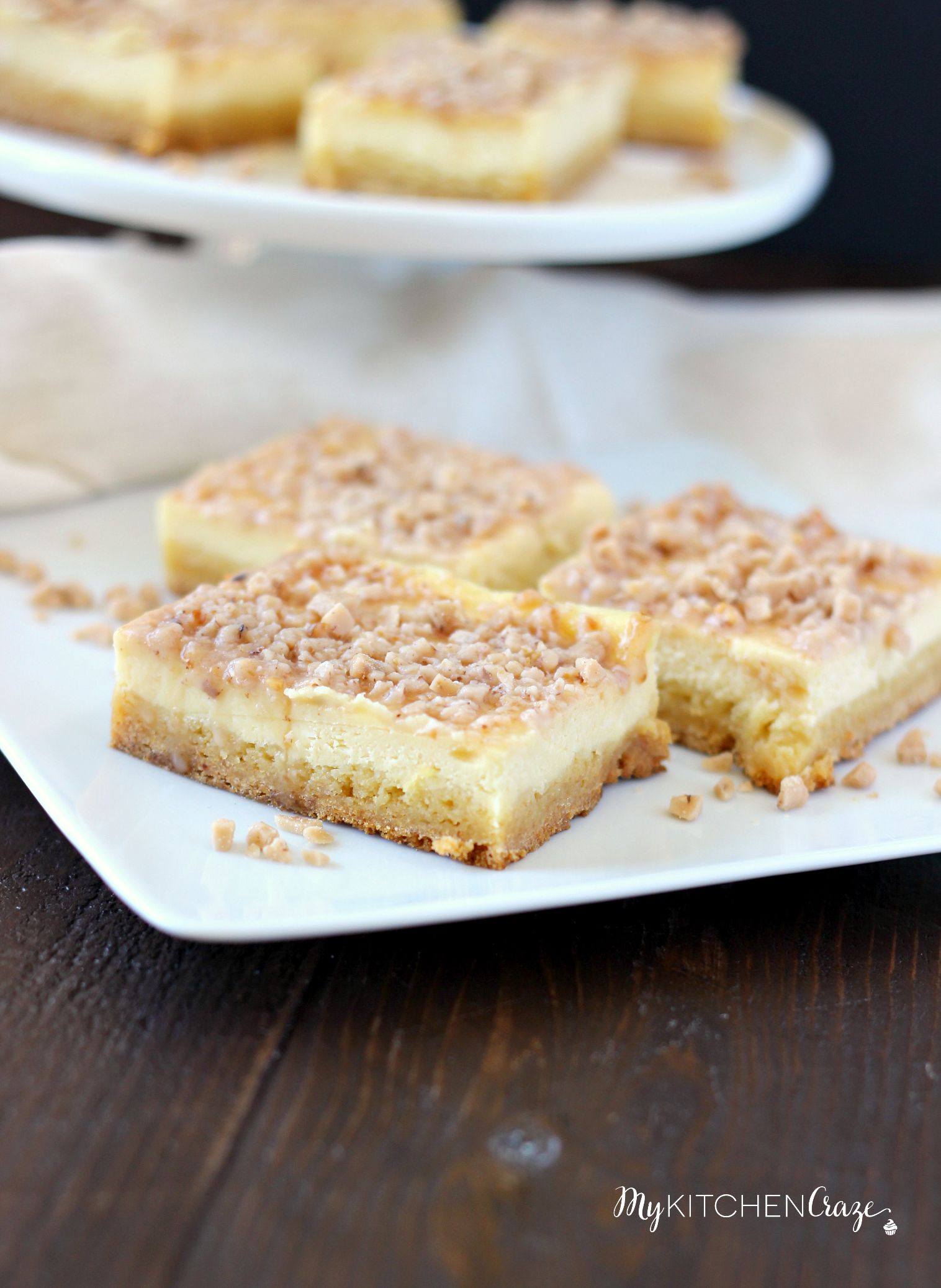 Toffee Cheesecake Bars ~ mykitchencraze ~ These bars are not only easy to throw together, but taste amazing! Sugar cookie bottom. Topped with a creamy cheesecake and sprinkled with toffee bits. What more could you ask for?