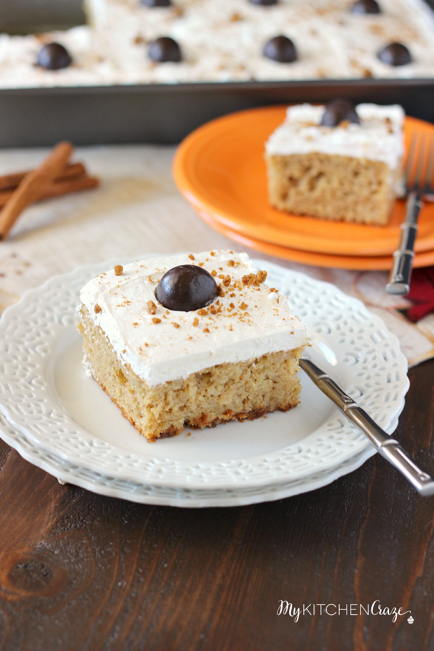 Spiced Pumpkin Poke Cake ~ mykitchencraze.com ~ Moist spiced pumpkin cake smothered with condensed milk, then topped with a cream cheese whipped frosting and a dark chocolate pumpkin. Delicious!