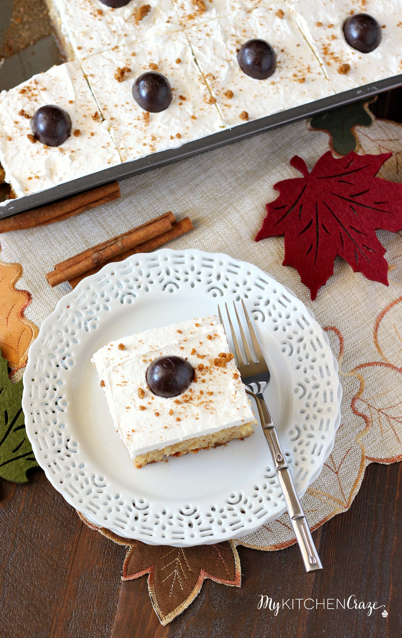 Spiced Pumpkin Poke Cake ~ mykitchencraze.com ~ Moist spiced pumpkin cake smothered with condensed milk, then topped with a cream cheese whipped frosting and a dark chocolate pumpkin. Delicious!