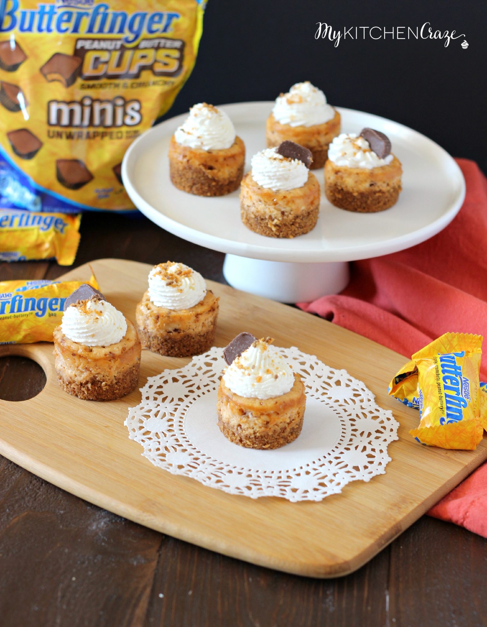 Mini Butterfinger Cheesecakes ~ mykitchencraze.com ~ Delicious cheesecakes swirled with butterfingers candies and topped with whipped cream! Yum!