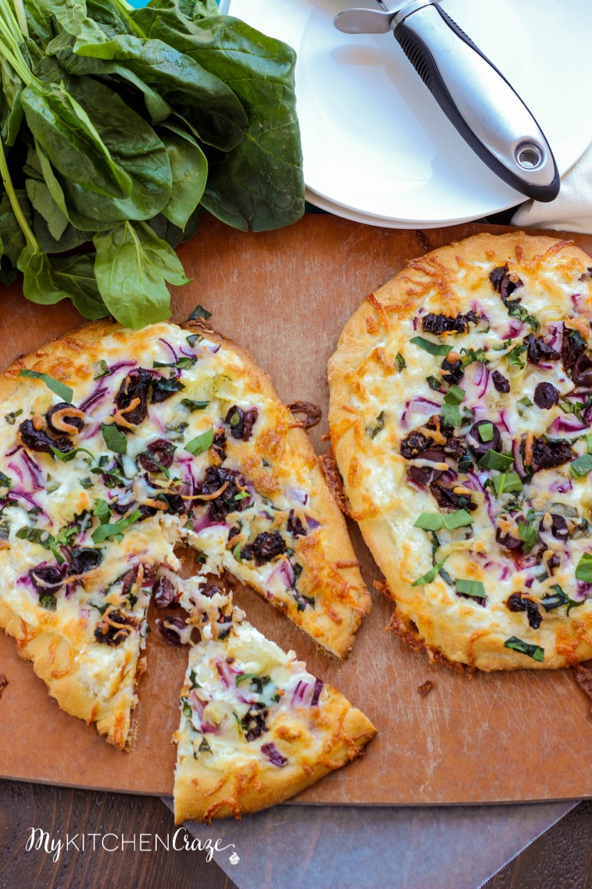 Mediterranean Pizza ~ mykitchencraze.com ~ Enjoy this delicious pizza filled with olives, sun-dried tomatoes, red onions and a yummy spinach, artichoke and garlic spread. Pizza night never looked so good.