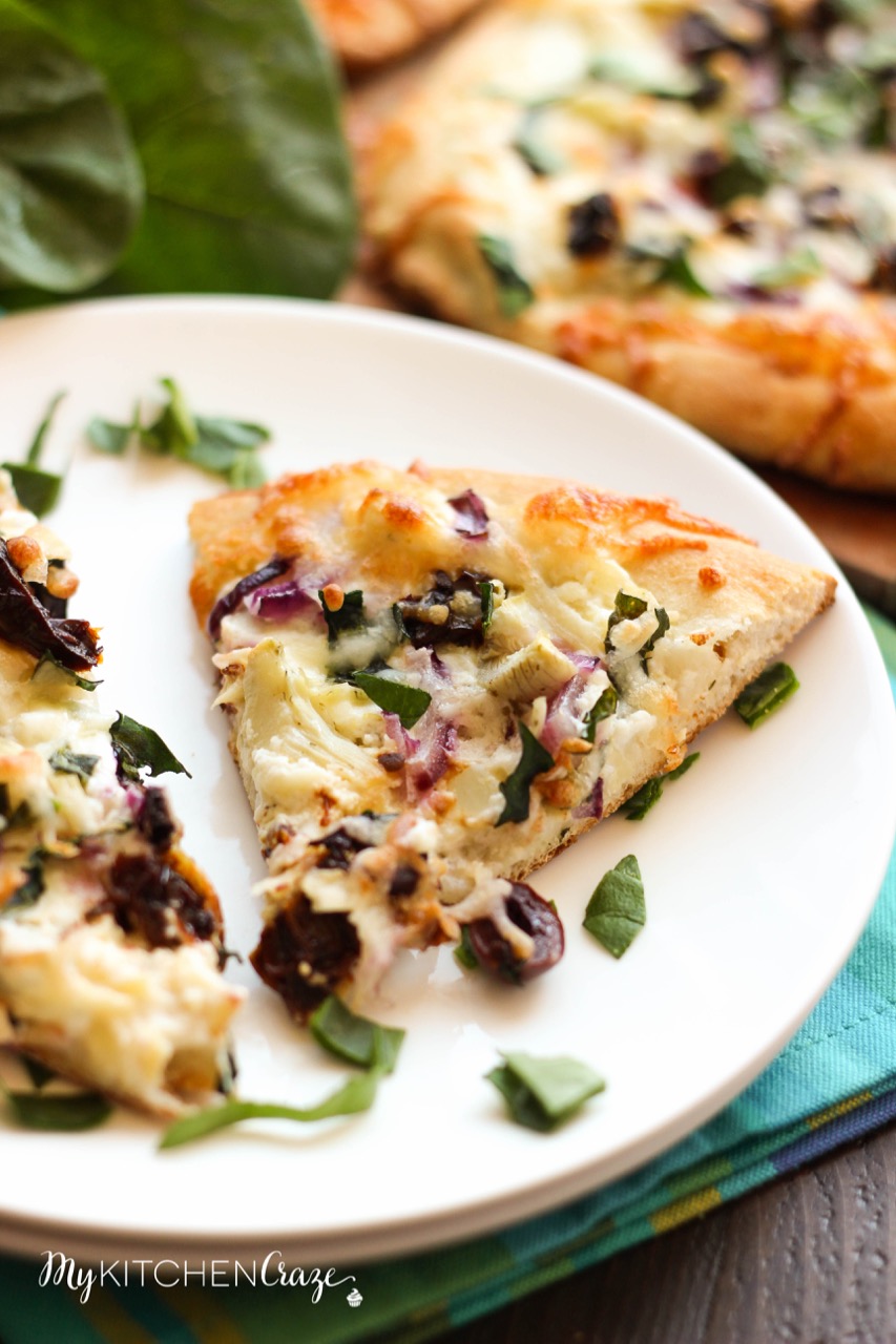 Mediterranean Pizza ~ mykitchencraze.com ~ Enjoy this delicious pizza filled with olives, sun-dried tomatoes, red onions and a yummy spinach, artichoke and garlic spread. Pizza night never looked so good.