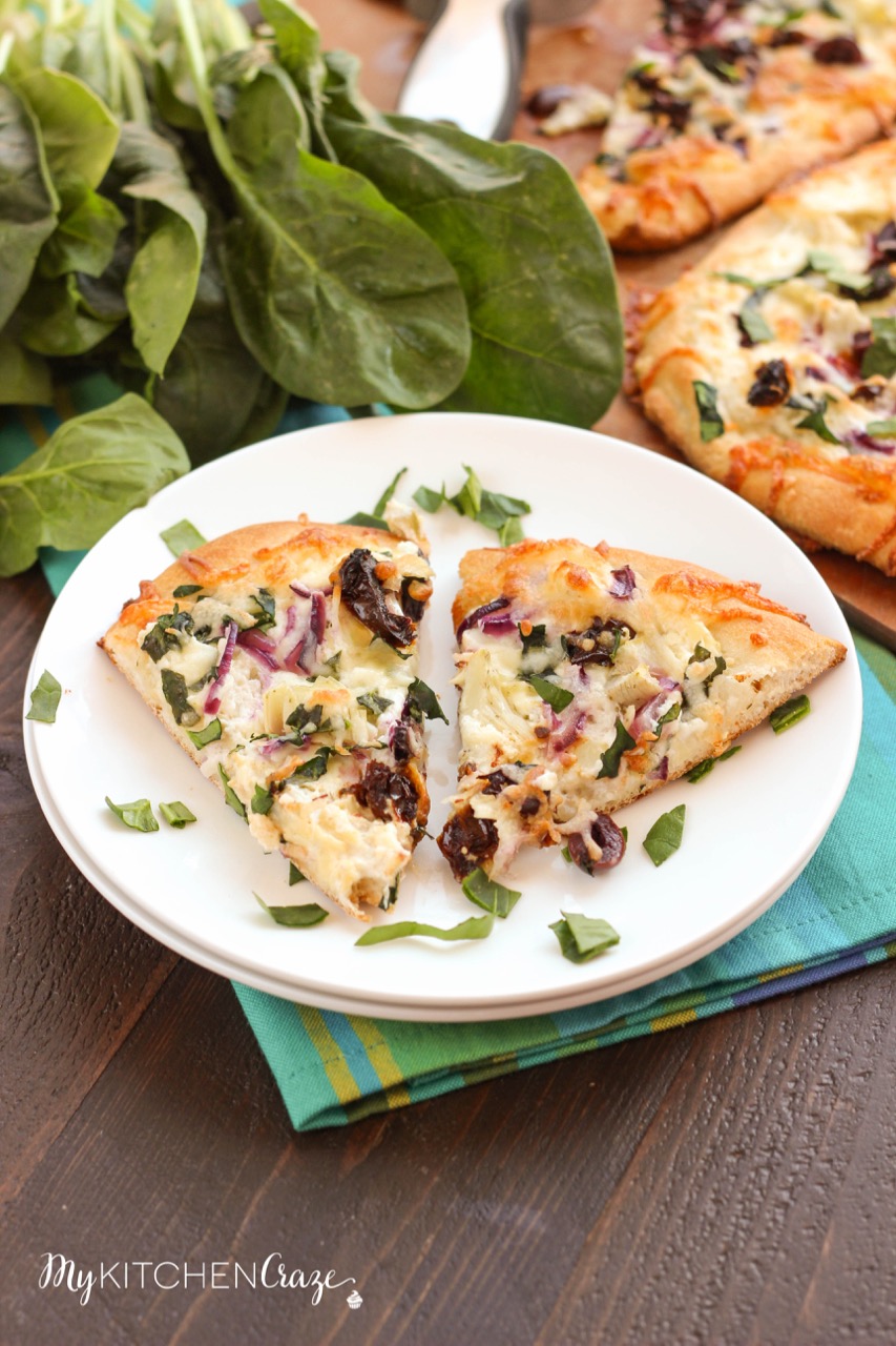 Mediterranean Pizza ~ mykitchencraze.com ~ Enjoy this delicious pizza filled with olives, sun-dried tomatoes, red onions and a yummy spinach, artichoke and garlic spread. Pizza night never looked so good.