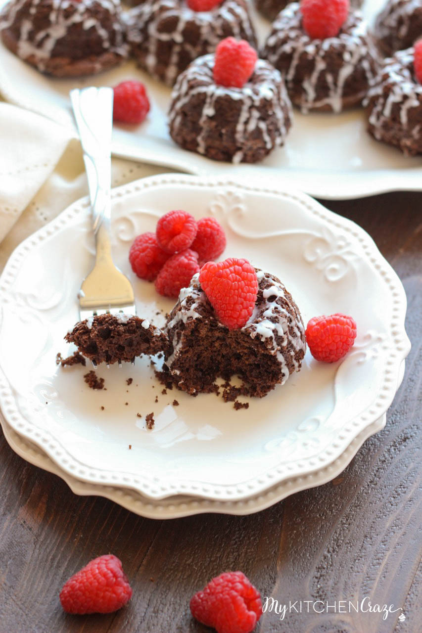 Mini Chocolate Bundt Cakes ~ mykitchencraze.com ~ Moist chocolate cake topped off with a vanilla glaze and raspberry. Perfect for a special gathering or any occasion.