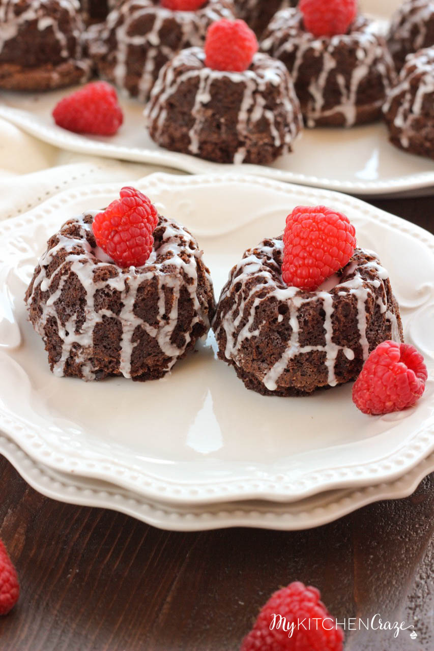 Mini Chocolate Bundt Cakes ~ mykitchencraze.com ~ Moist chocolate cake topped off with a vanilla glaze and raspberry. Perfect for a special gathering or any occasion.