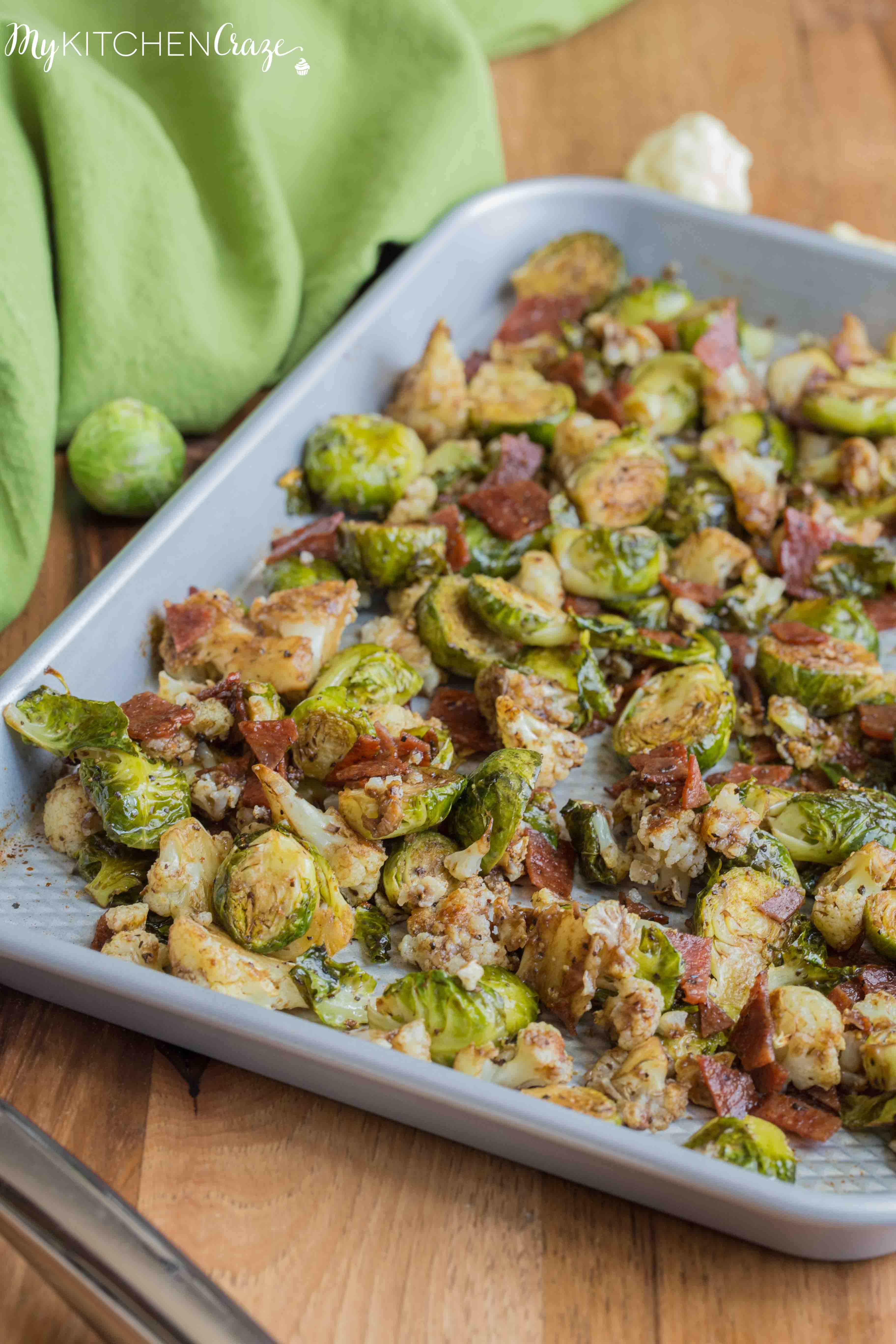 Roasted Brussel Sprouts with Bacon & Cauliflower ~ mykitchencraze.com ~ A delicious side dish loaded with roasted Brussel Sprouts and cauliflower, crispy bacon. Then topped with a delicious balsamic vinaigrette. It's the perfect side dish for any meat and the kids will love it!