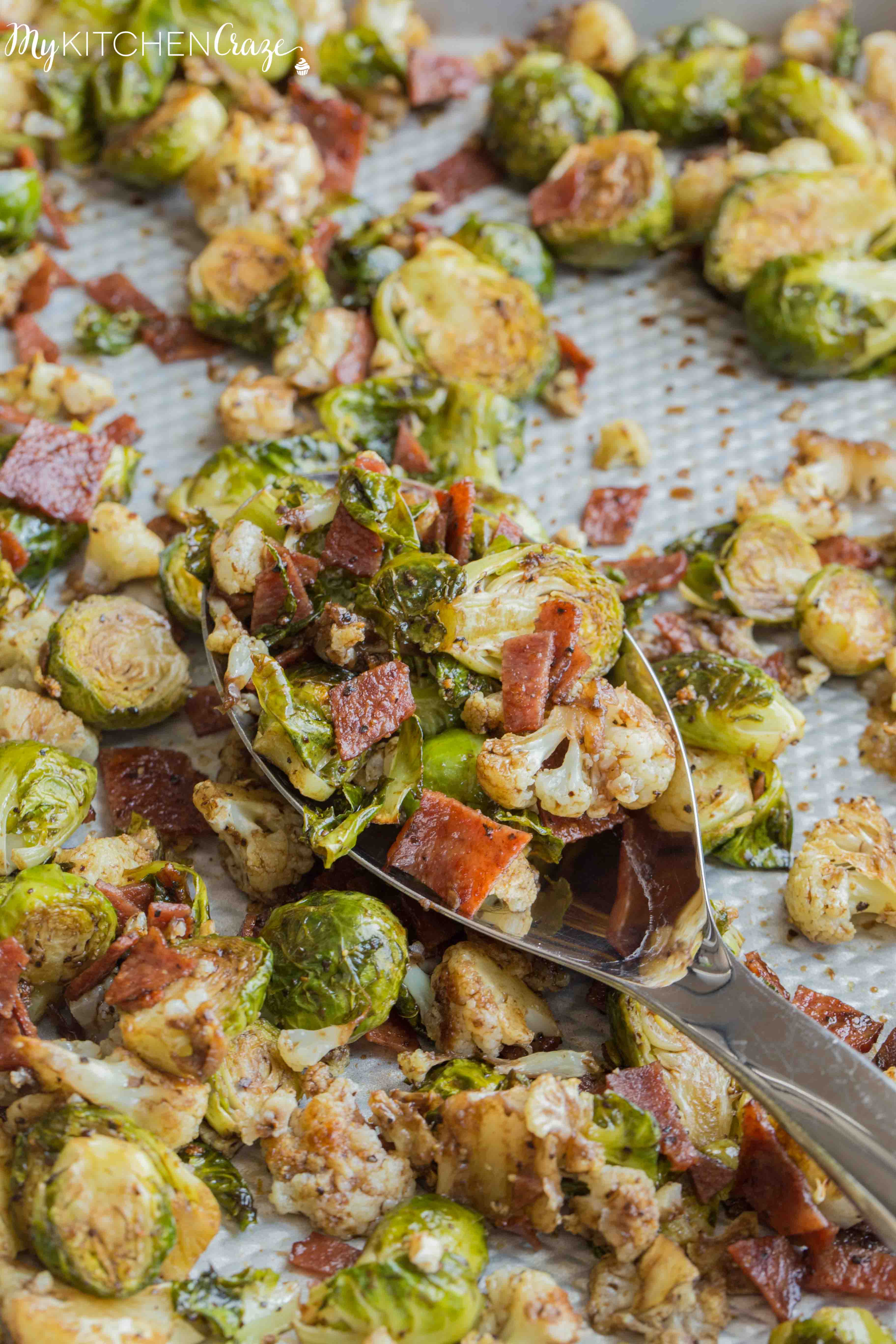Roasted Brussel Sprouts with Bacon & Cauliflower ~ mykitchencraze.com ~ A delicious side dish loaded with roasted Brussel Sprouts and cauliflower, crispy bacon. Then topped with a delicious balsamic vinaigrette. It's the perfect side dish for any meat and the kids will love it!