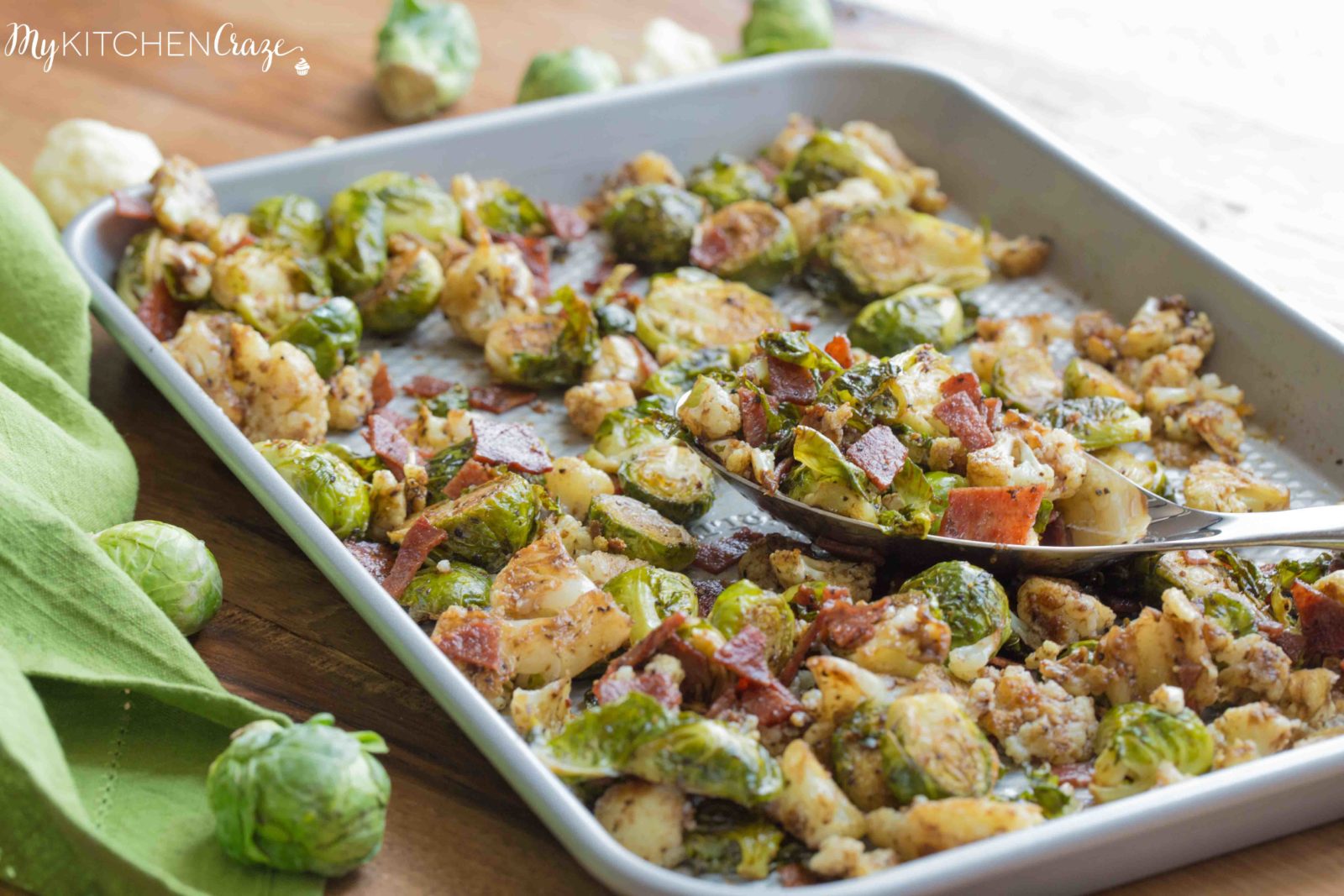 Roasted Brussel Sprouts with Bacon & Cauliflower ~ mykitchencraze.com ~ A delicious side dish loaded with roasted Brussel Sprouts and cauliflower, crispy bacon. Then topped with a delicious balsamic vinaigrette. It's the perfect side dish for any meat and the kids will love it!