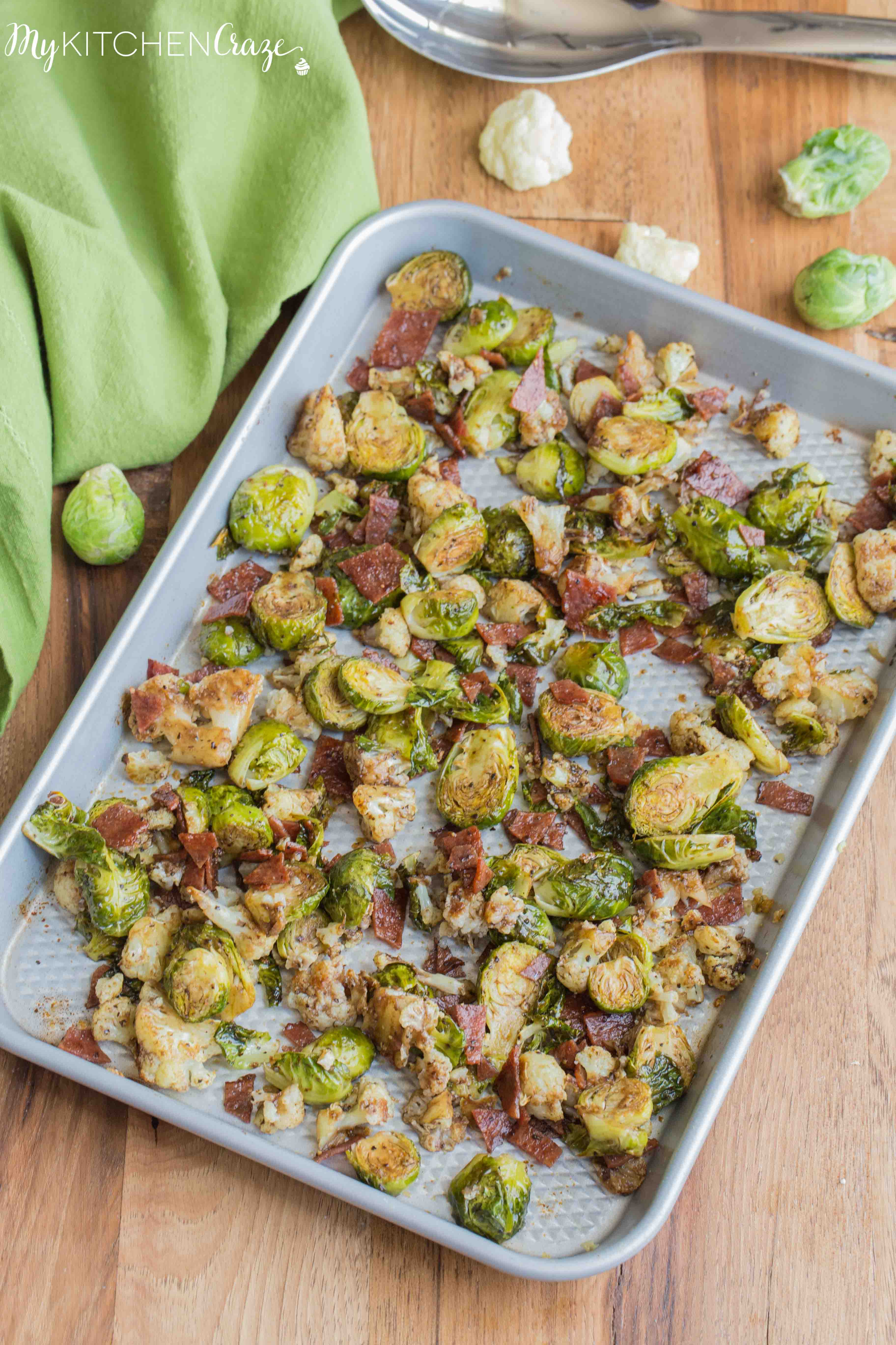 Roasted Brussel Sprouts with Bacon & Cauliflower ~ mykitchencraze.com ~ A delicious side dish loaded with roasted Brussel Sprouts and cauliflower, crispy bacon. Then topped with a delicious balsamic vinaigrette. It's the perfect side dish for any meat and the kids will love it!