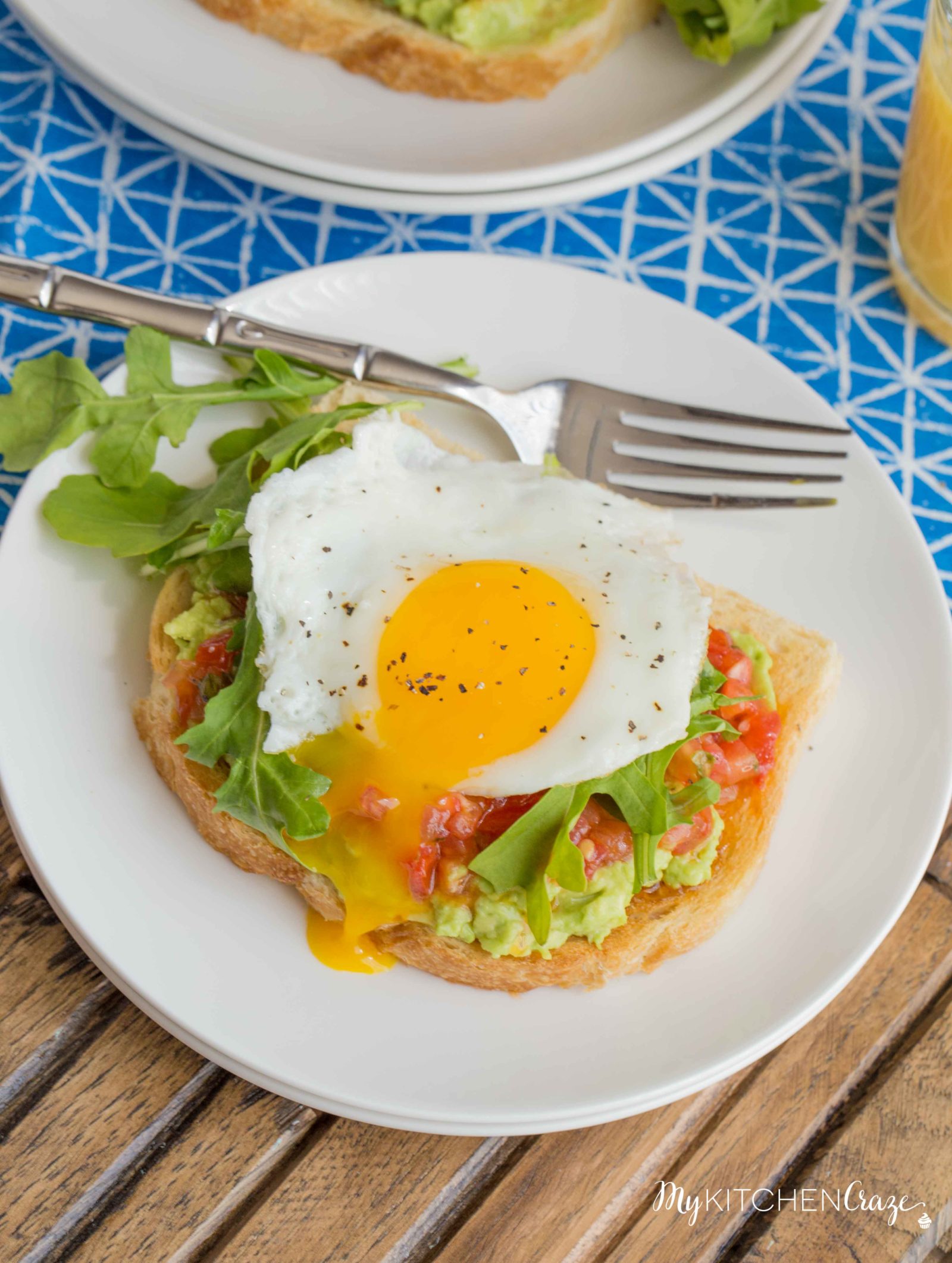 Bruschetta Egg Avocado Toast ~ mykitchencraze.com ~ Sourdough toast loaded with avocado, bruschetta and arugula, then topped with an egg. Perfect way to start your morning!