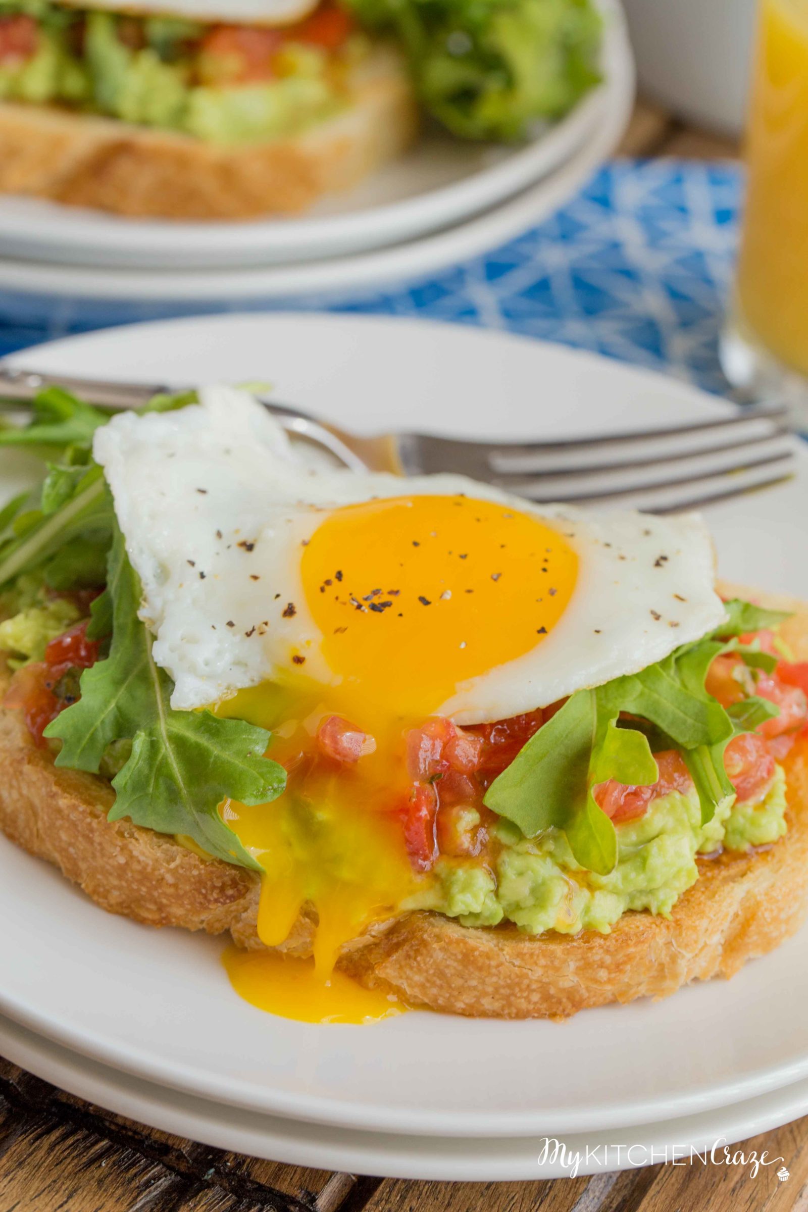 Bruschetta Egg Avocado Toast ~ mykitchencraze.com ~ Sourdough toast loaded with avocado, bruschetta and arugula, then topped with an egg. Perfect way to start your morning!