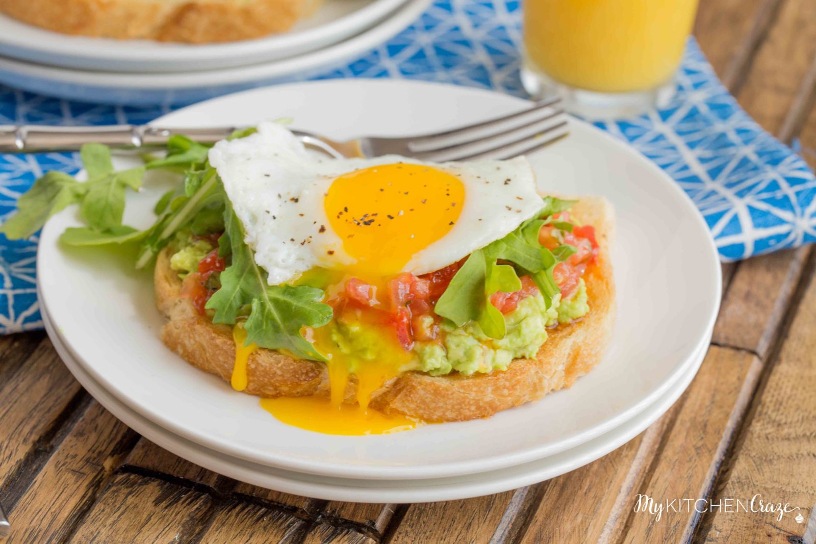 Bruschetta Egg Avocado Toast ~ mykitchencraze.com ~ Sourdough toast loaded with avocado, bruschetta and arugula, then topped with an egg. Perfect way to start your morning!