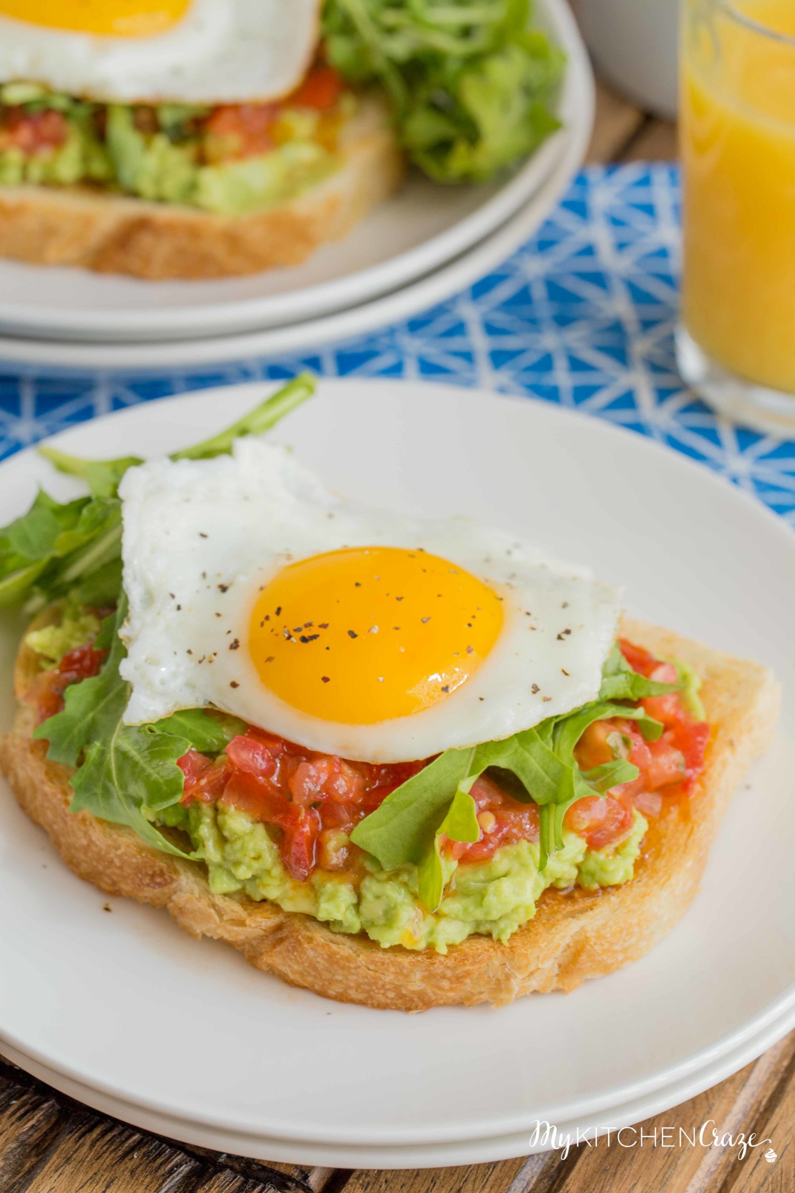 Bruschetta Egg Avocado Toast ~ mykitchencraze.com ~ Sourdough toast loaded with avocado, bruschetta and arugula, then topped with an egg. Perfect way to start your morning!