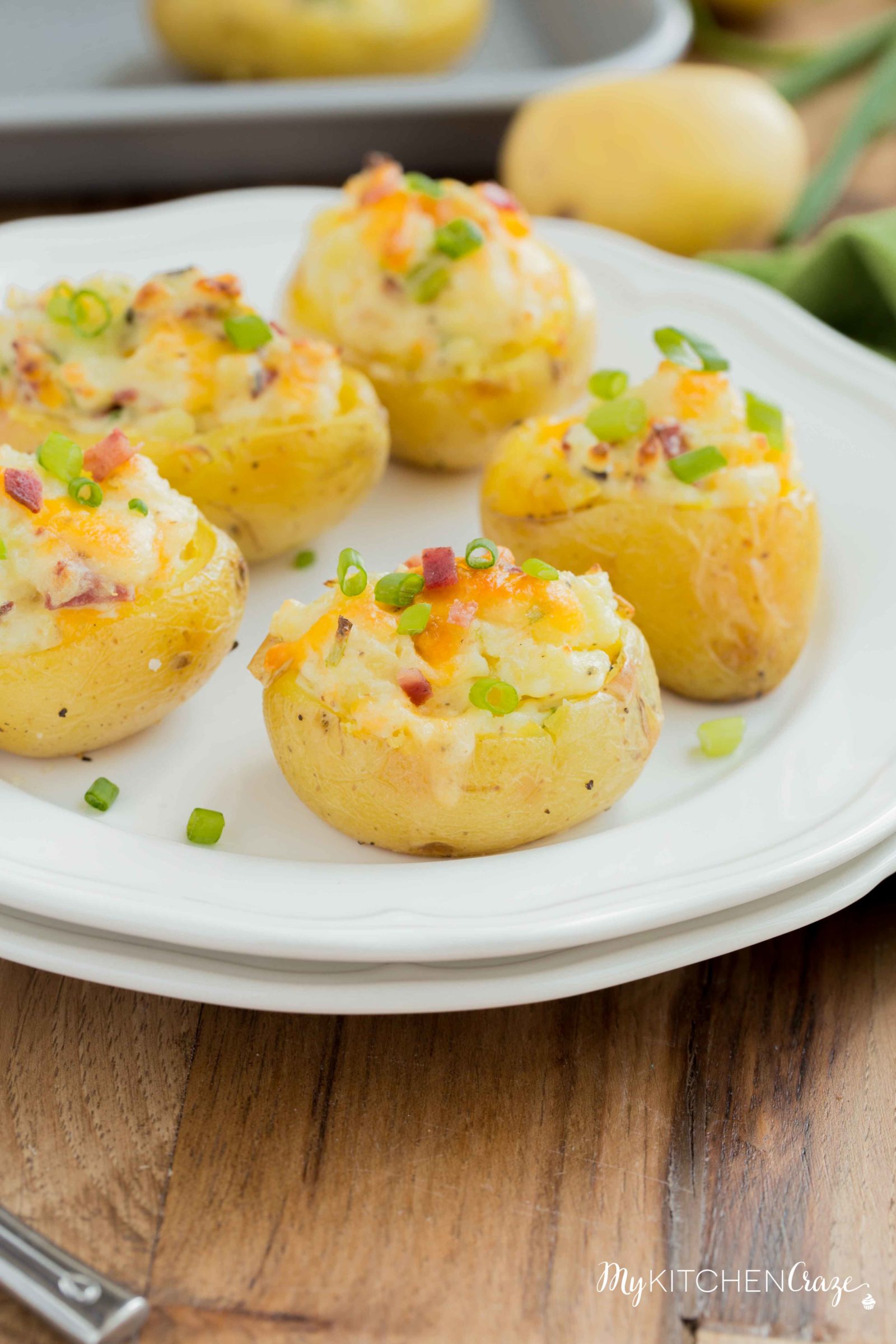 Mini Twice Baked Potatoes ~ Potatoes baked to perfection then loaded with bacon, green onions and cheese. All the yummy things you need for a side! These mini twice baked potatoes are the perfect side.