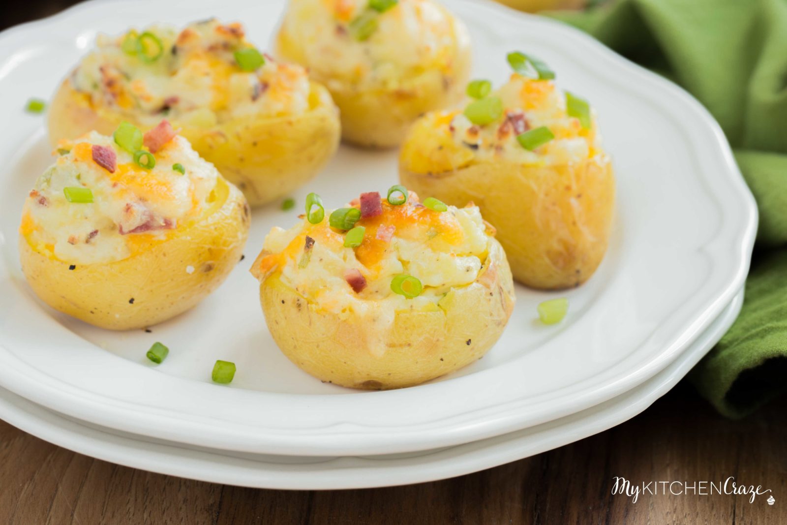 Mini Twice Baked Potatoes ~ Potatoes baked to perfection then loaded with bacon, green onions and cheese. All the yummy things you need for a side! These mini twice baked potatoes are the perfect side.