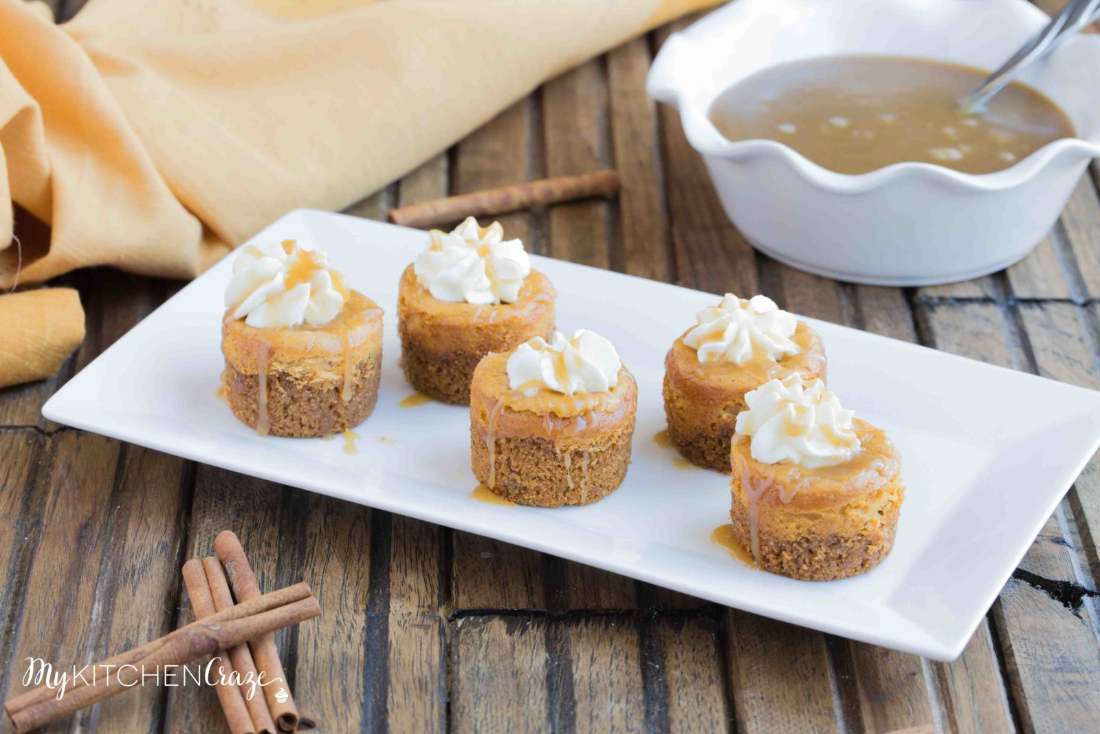 Mini Pumpkin Cheesecakes are the perfect fall dessert! Creamy cheesecake has the perfect hint of pumpkin, topped with homemade whipped cream and caramel sauce. It doesn't get much better than these cute mini cheesecakes this season!