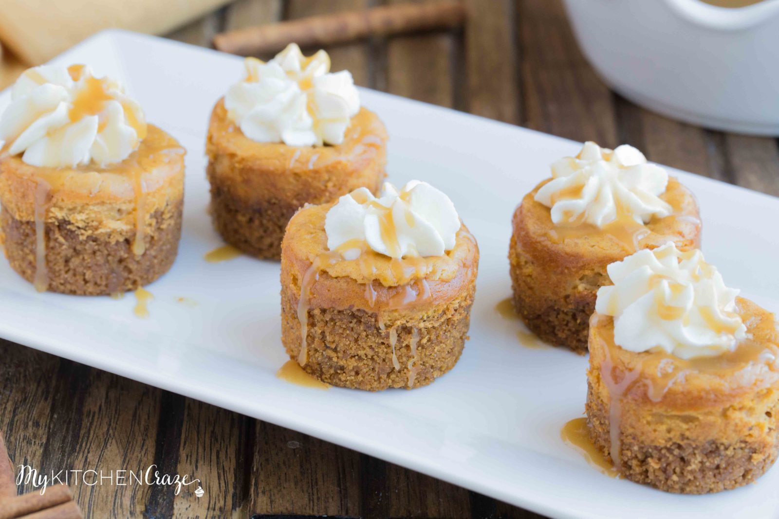 Mini Pumpkin Cheesecakes are the perfect fall dessert! Creamy cheesecake has the perfect hint of pumpkin, topped with homemade whipped cream and caramel sauce. It doesn't get much better than these cute mini cheesecakes this season!