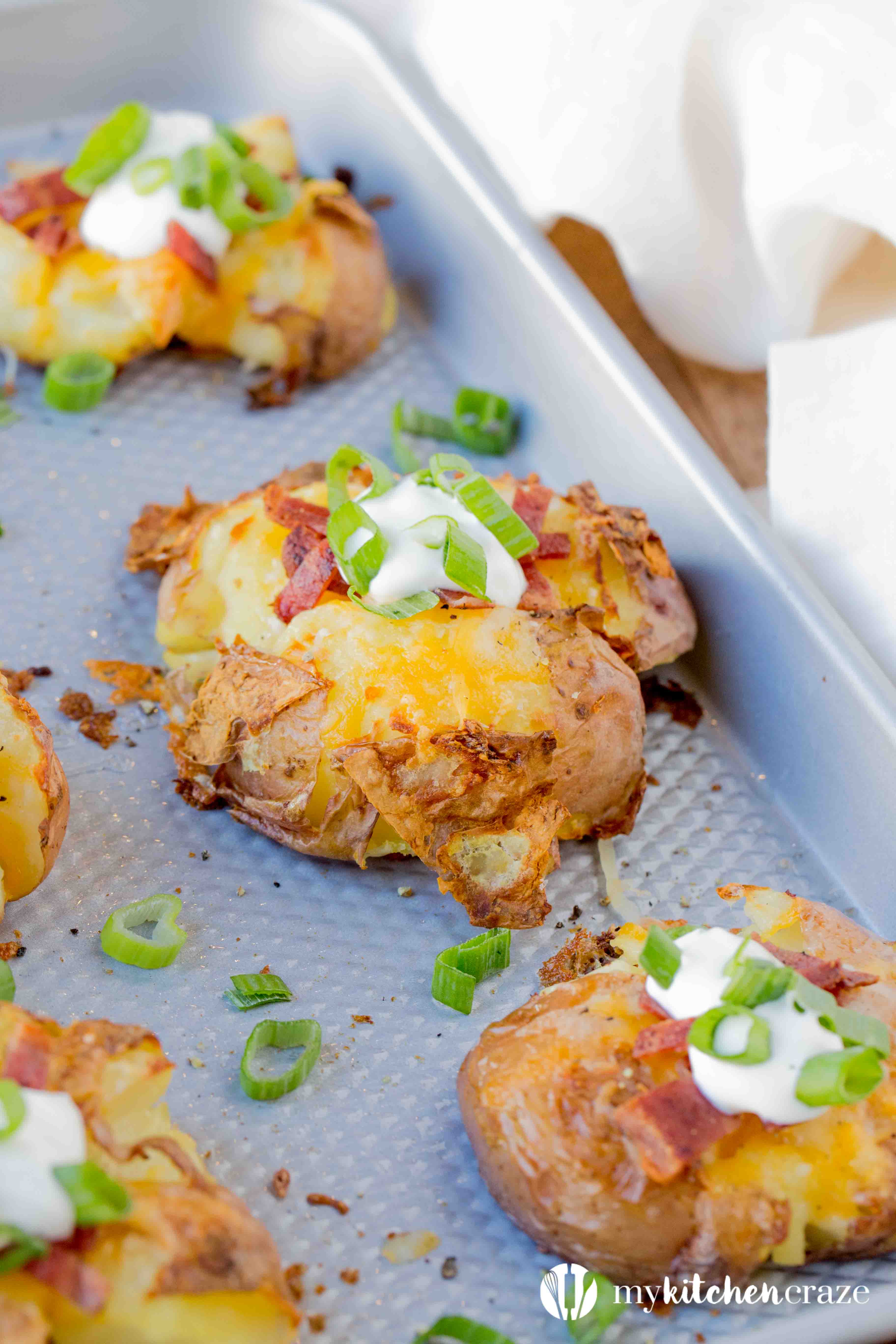 Loaded Smashed Potatoes are a no fuss and delicious side dish. Loaded with all the yummy things you'd find in a loaded baked potato. This is one side everyone will love!