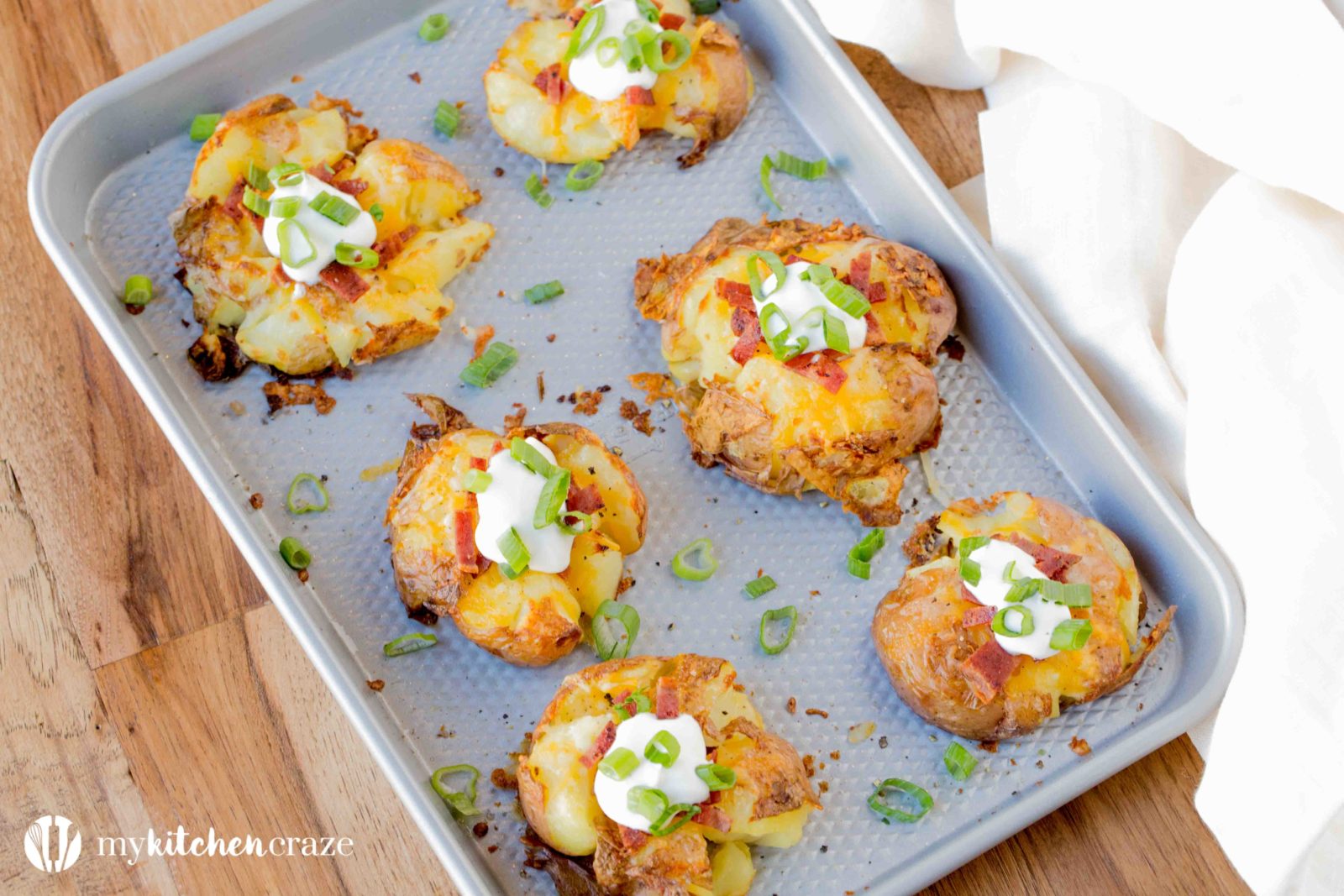 Loaded Smashed Potatoes are a no fuss and delicious side dish. Loaded with all the yummy things you'd find in a loaded baked potato. This is one side everyone will love!