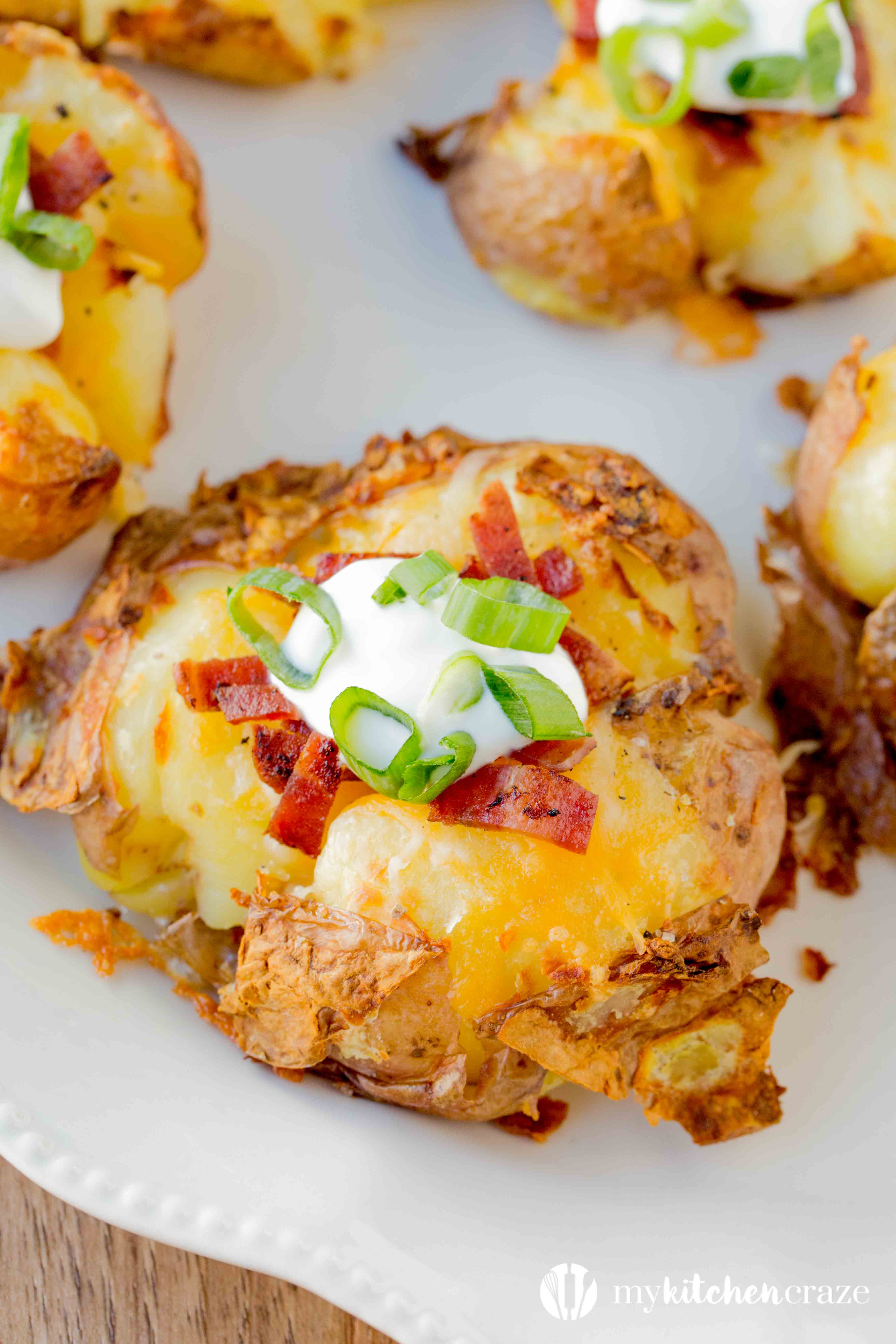 Loaded Smashed Potatoes are a no fuss and delicious side dish. Loaded with all the yummy things you'd find in a loaded baked potato. This is one side everyone will love!