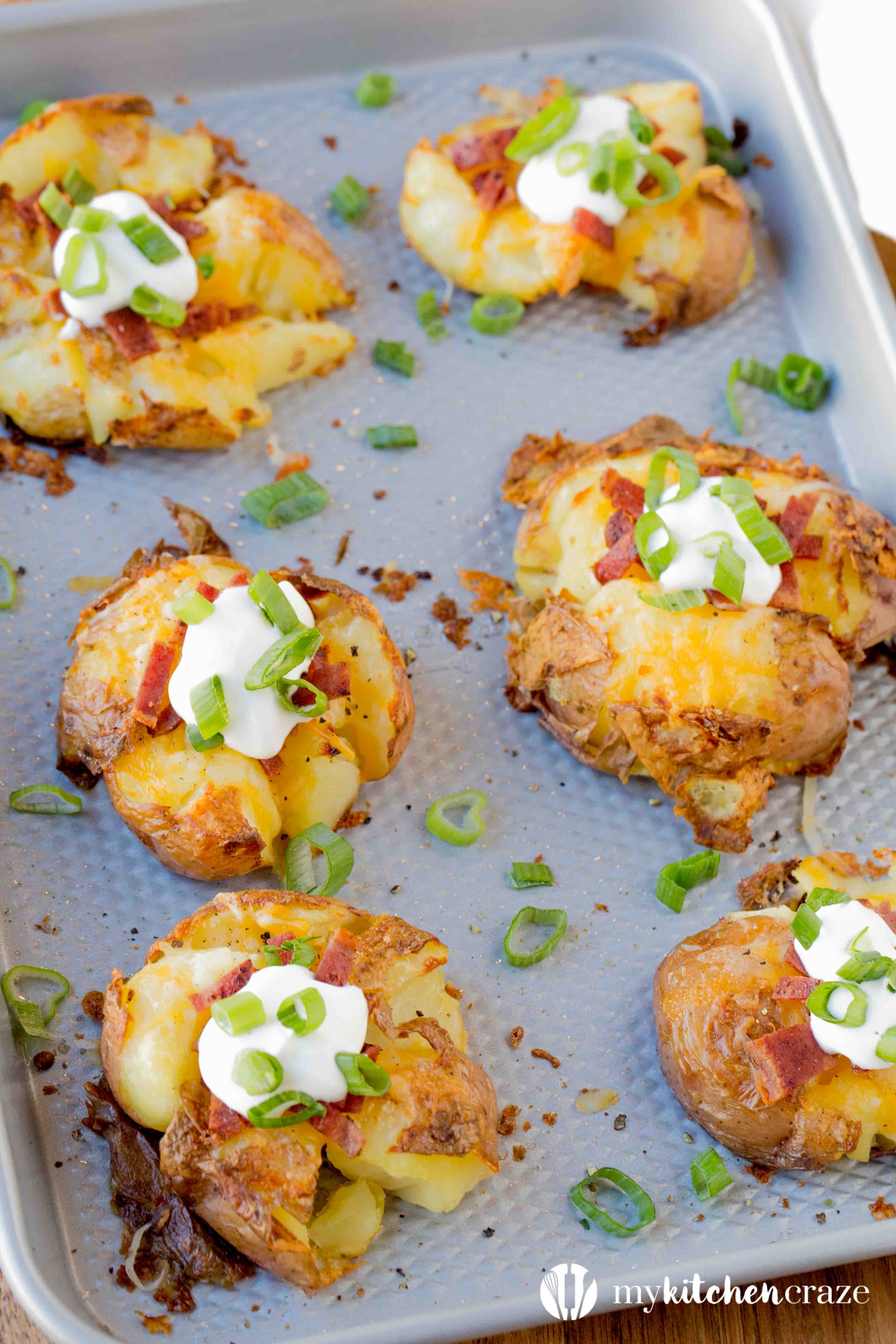 Loaded Smashed Potatoes are a no fuss and delicious side dish. Loaded with all the yummy things you'd find in a loaded baked potato. This is one side everyone will love!