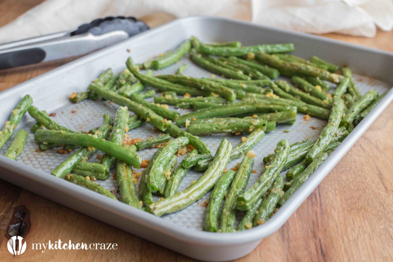 Baked Garlic Green Beans are a simple and delicious side dish that will compliment any main entree. Crunchy green beans and roasted garlic, make this one easy yummy side!