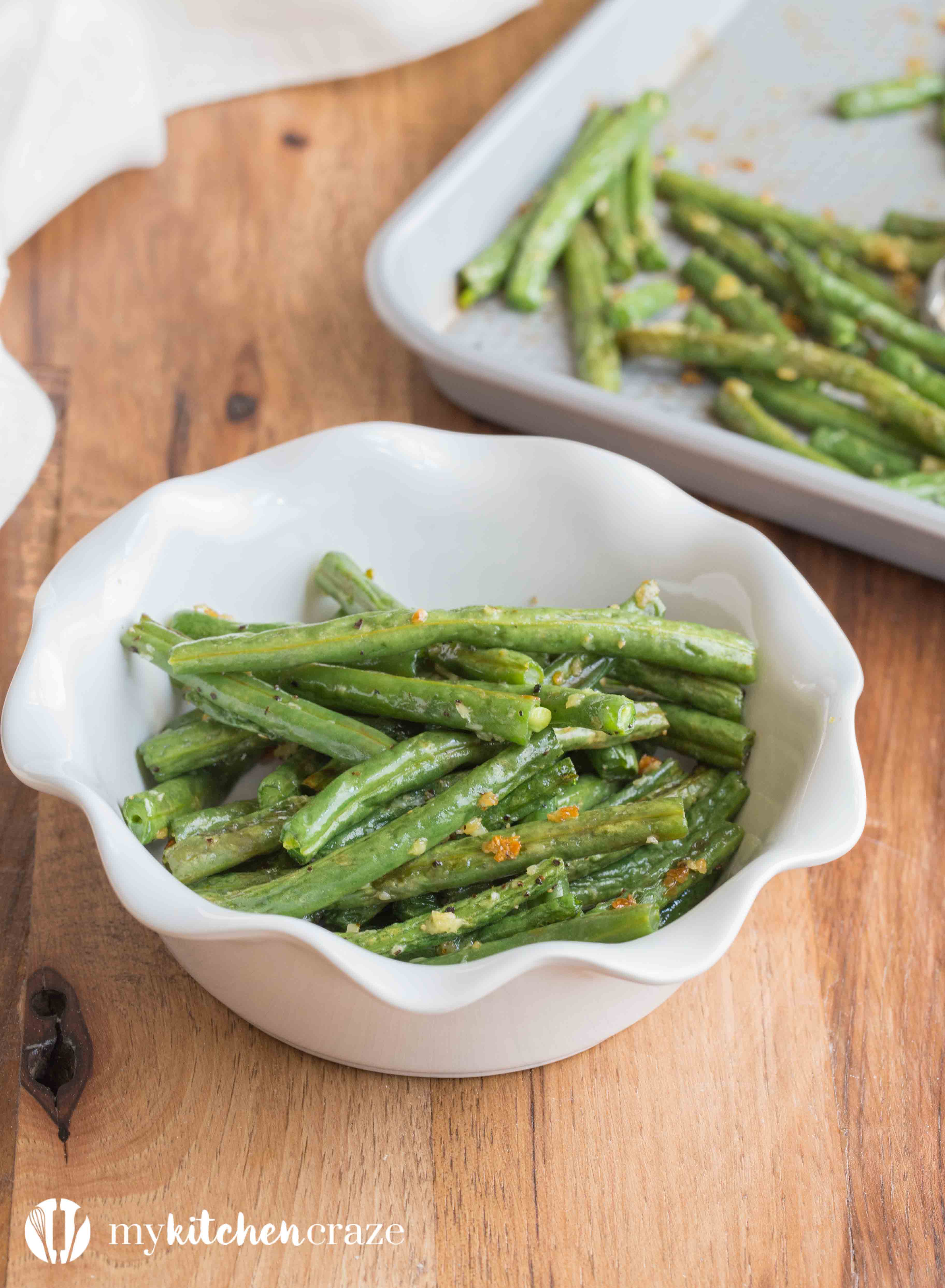 Baked Garlic Green Beans are a simple and delicious side dish that will compliment any main entree. Crunchy green beans and roasted garlic, make this one easy yummy side!