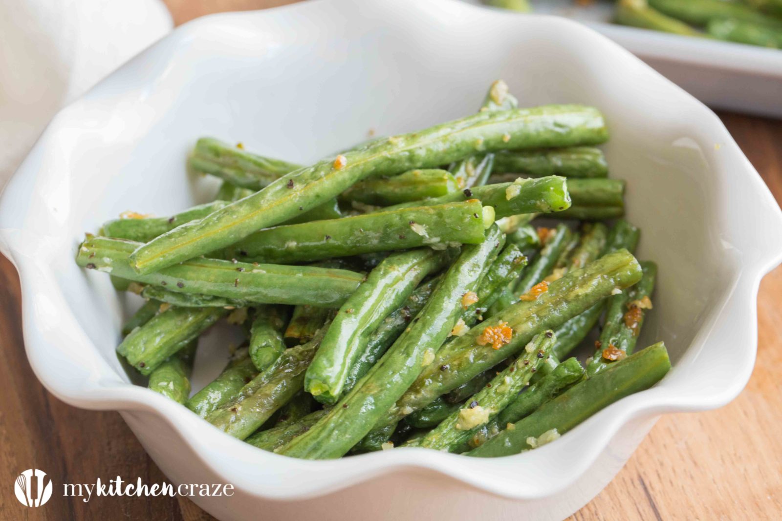 Baked Garlic Green Beans are a simple and delicious side dish that will compliment any main entree. Crunchy green beans and roasted garlic, make this one easy yummy side!