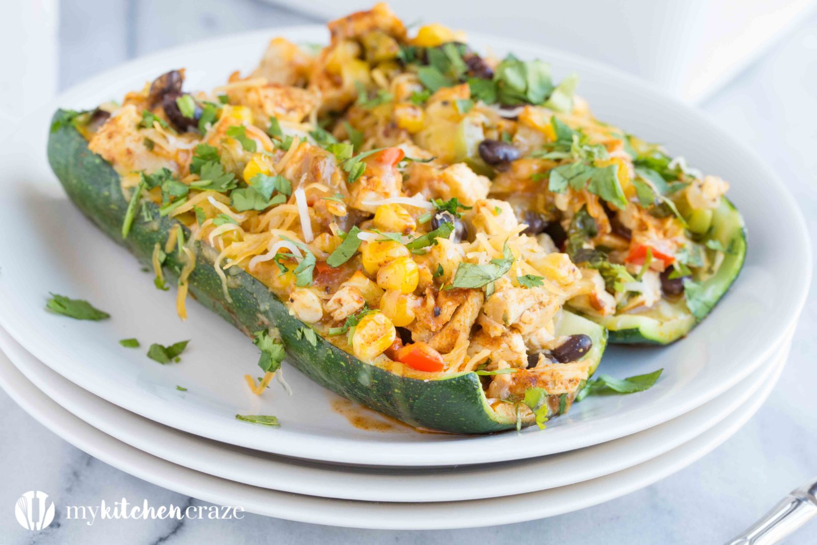 Chicken Enchilada Zucchini Boats are filled with all the same delicious flavors as regular enchiladas, but are healthier! Loaded with tons of veggies and yummy flavors, these enchiladas are great for dinner!