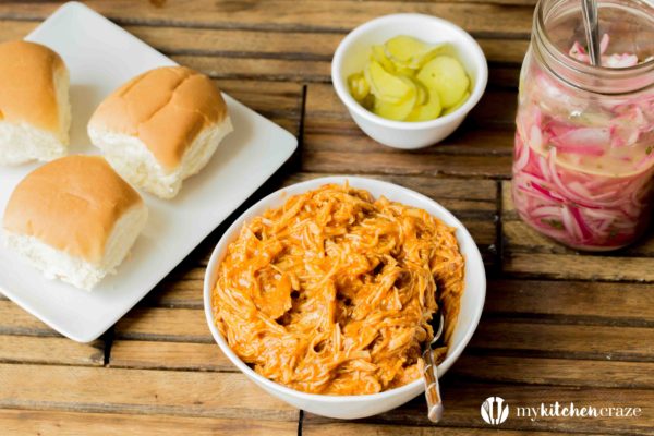 BBQ Pulled Chicken Sliders are packed with delicious flavor! The chicken is slow cooked with Barbecue sauce then shredded or 'pulled' and piled on top of slider rolls. Perfect for a busy night or a fun gathering!