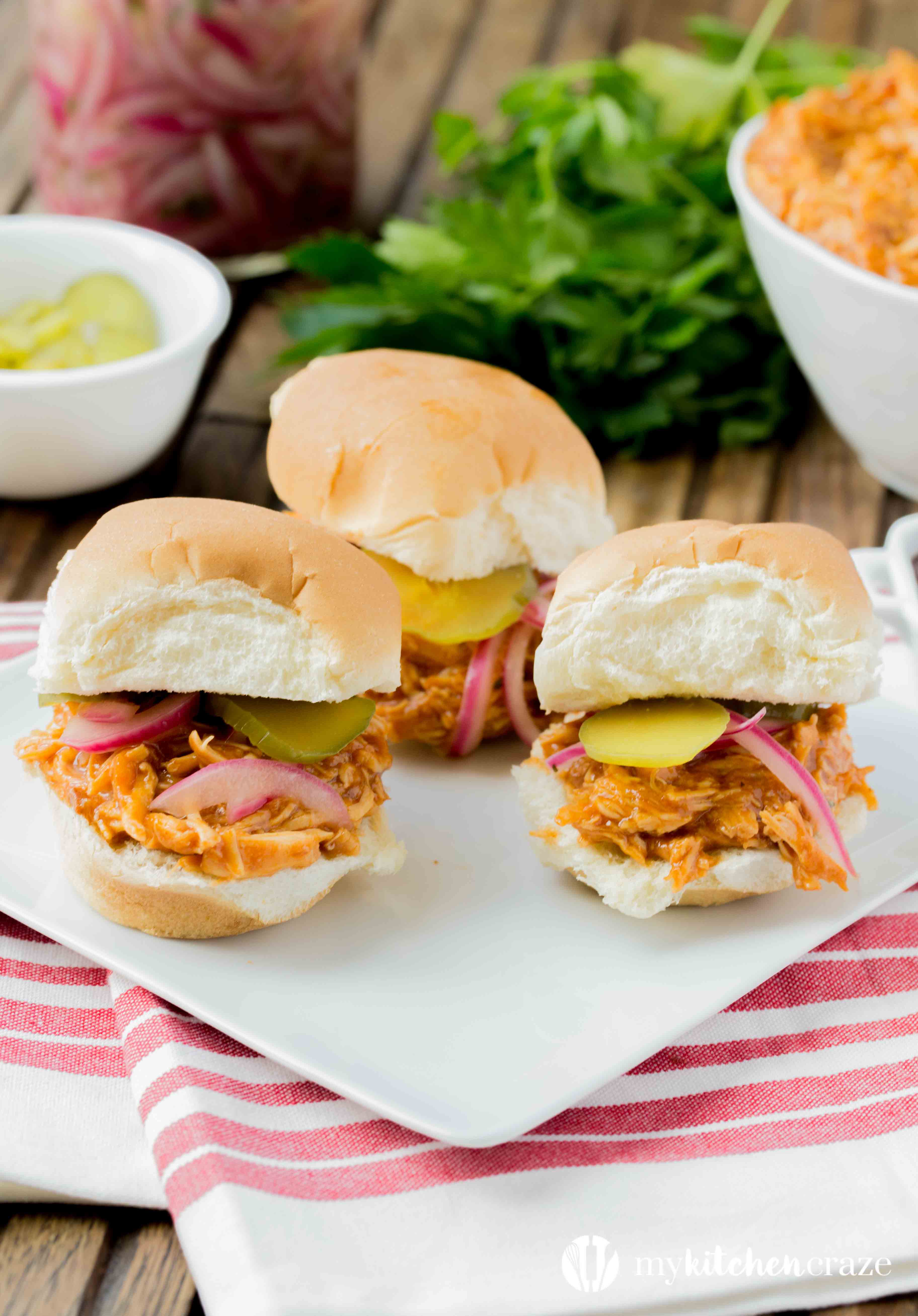 BBQ Pulled Chicken Sliders are packed with delicious flavor! The chicken is slow cooked with Barbecue sauce then shredded or 'pulled' and piled on top of slider rolls. Perfect for a busy night or a fun gathering! 