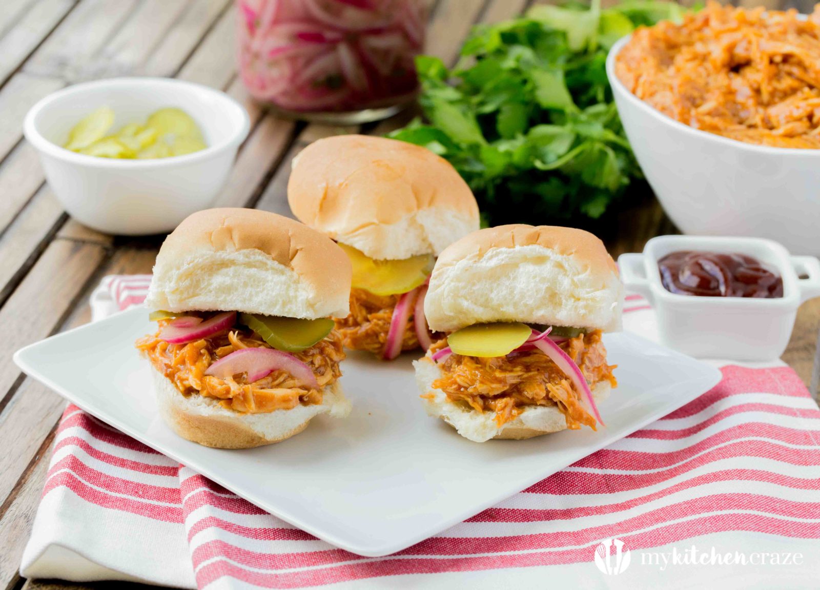 BBQ Pulled Chicken Sliders are packed with delicious flavor! The chicken is slow cooked with Barbecue sauce then shredded or 'pulled' and piled on top of slider rolls. Perfect for a busy night or a fun gathering! 