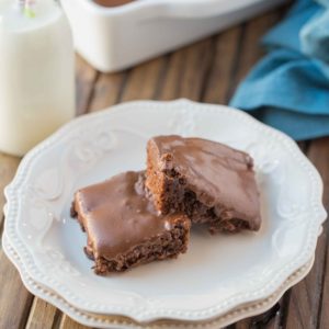 Frosted Brownies are a must have recipe! Brownies that are moist, delicious and the frosting takes these brownies to a whole new level. Grab that glass of milk because you'll want it with a slice of these yummy Frosted Brownies!
