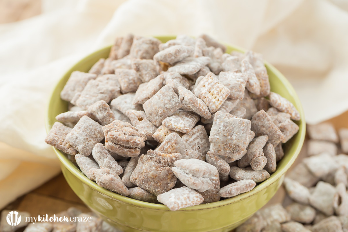 Muddy Buddies ~ crunchy cereal coated with chocolate, peanut butter and powered sugar. This is one kid approved snack and the best news is it takes minutes to throw together!