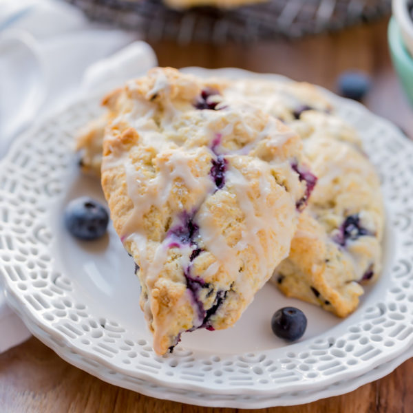 Blueberry Scones with Vanilla Glaze are perfect for a quick grab and go breakfast. They're crunchy around the edges but moist in the center. Topped with a vanilla glaze to give them a bit of sweetness.