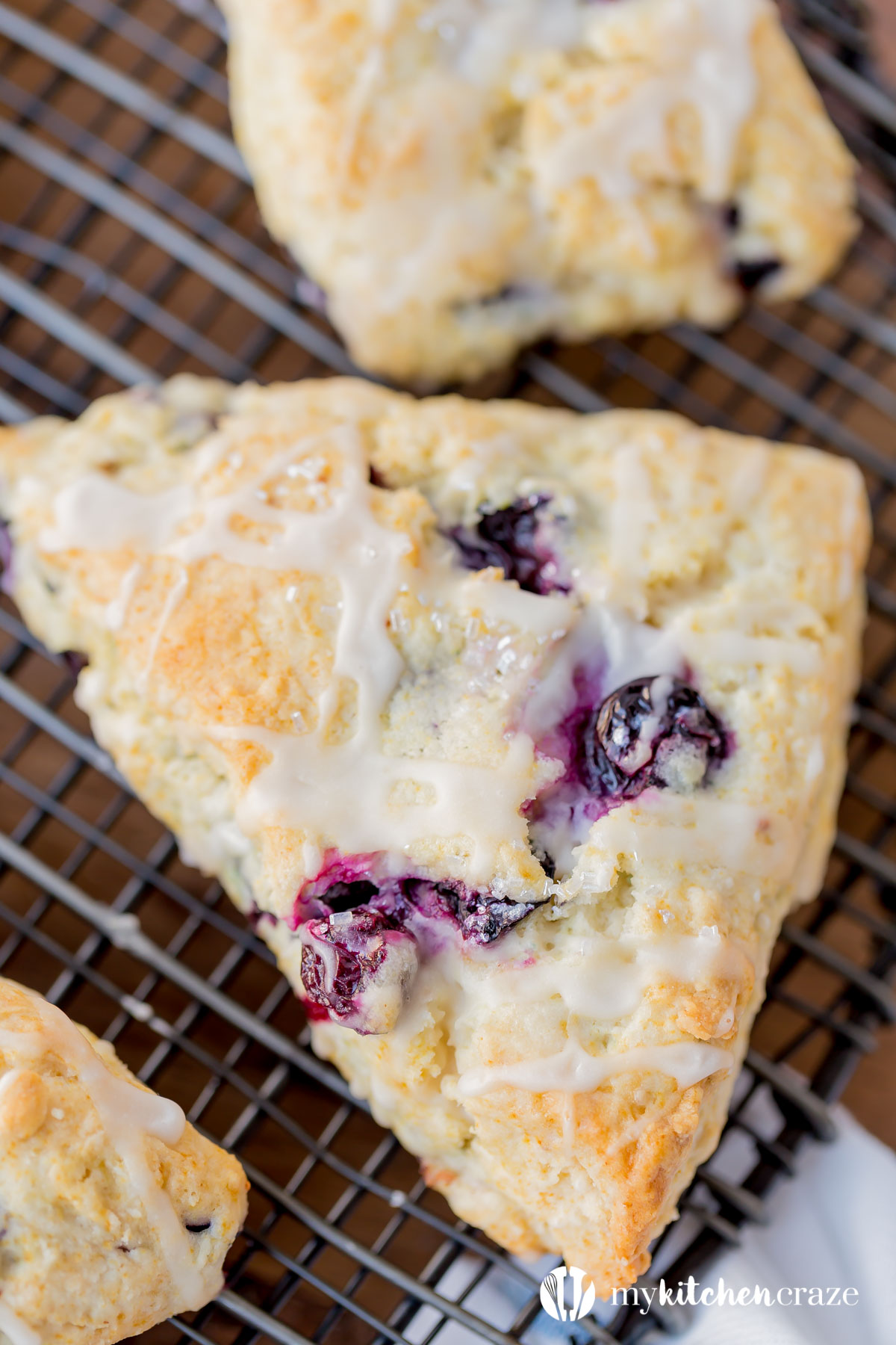 Blueberry Scones with Vanilla Glaze are perfect for a quick grab and go breakfast. They're crunchy around the edges but moist in the center. Topped with a vanilla glaze to give them a bit of sweetness.