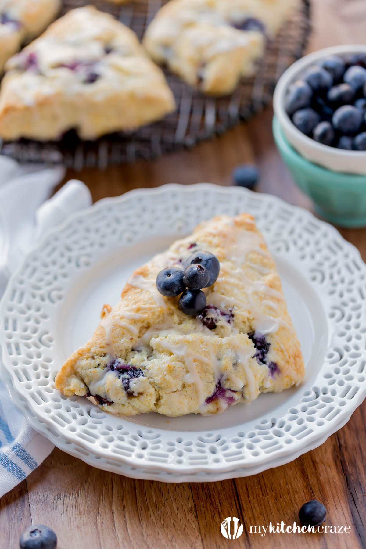 Blueberry Scones with Vanilla Glaze are perfect for a quick grab and go breakfast. They're crunchy around the edges but moist in the center. Topped with a vanilla glaze to give them a bit of sweetness.