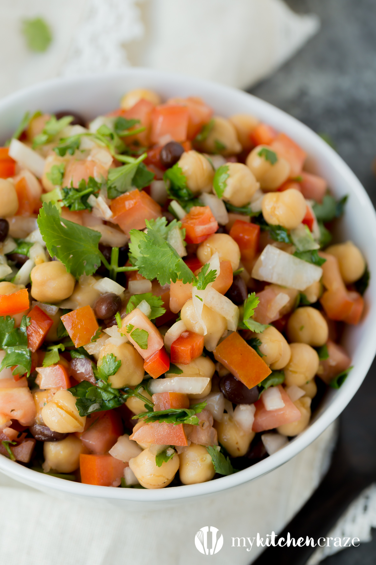 Simple, easy and fresh ingredients are the key to this delicious Tomato Chickpea Salad. You can use it as a side dish or eat it as the main with some protein. Either way, this salad is yummy.